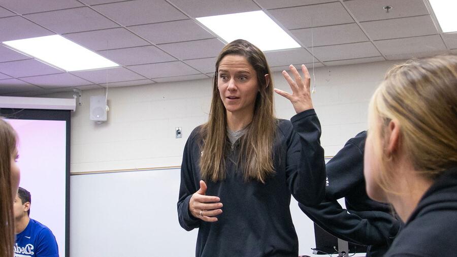 Professor Sam Wilson teaches in front of students in a classroom.